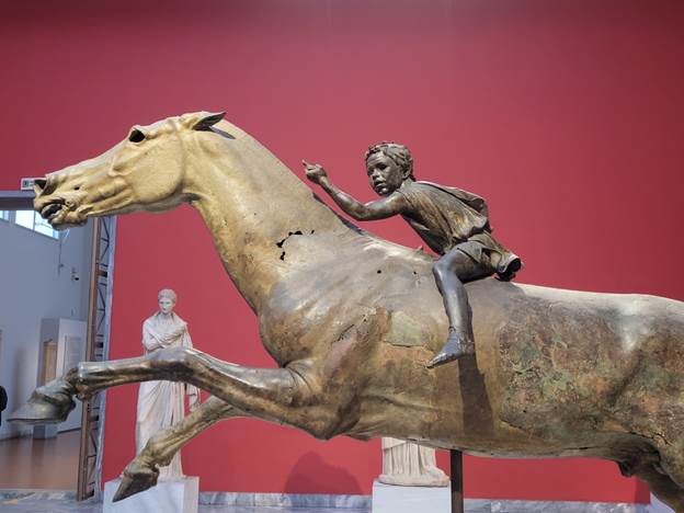 A statue of a person riding a horse

Description automatically generated